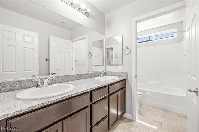 4519 Stardusk Falls Ave, North Las Vegas, NV 89084 - full bathroom featuring toilet, double vanity, shower / washtub combination, and tile patterned floors