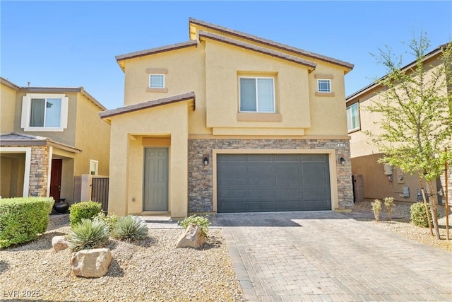 4519 Stardusk Falls Ave, North Las Vegas, NV 89084 - townhome / multi-family property with a garage, stone siding, stucco siding, and decorative driveway