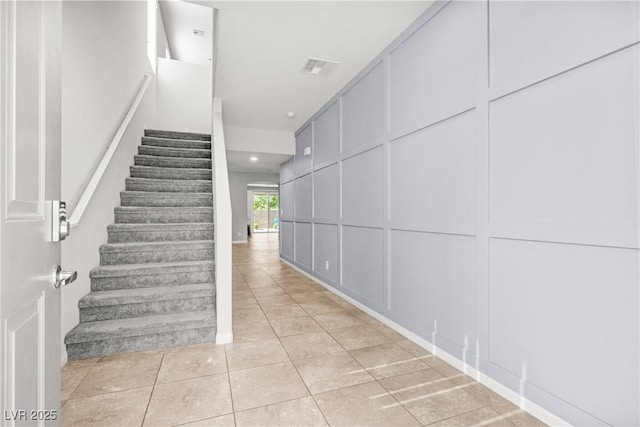 4519 Stardusk Falls Ave, North Las Vegas, NV 89084 - stairway featuring a decorative wall and tile patterned flooring
