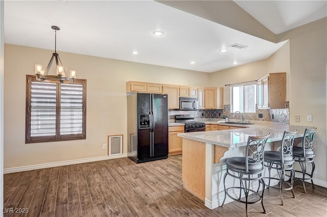 983 Cutter St, Henderson, NV 89011 - kitchen featuring black appliances, light brown cabinetry, wood finished floors, a peninsula, and recessed lighting