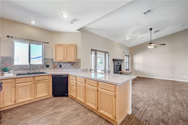983 Cutter St, Henderson, NV 89011 - kitchen with light brown cabinetry, dishwasher, a peninsula, light countertops, and light wood-style flooring