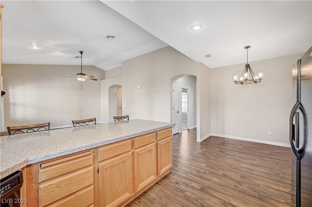 983 Cutter St, Henderson, NV 89011 - kitchen featuring arched walkways, black appliances, vaulted ceiling, ceiling fan, and light wood-style floors