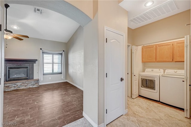 983 Cutter St, Henderson, NV 89011 - laundry room featuring independent washer and dryer, a ceiling fan, cabinet space, baseboards, and a fireplace