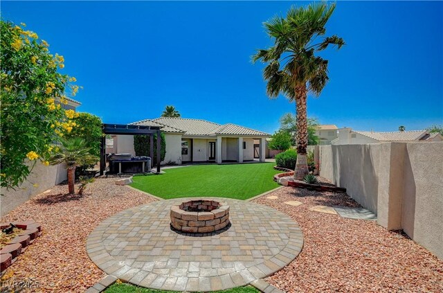 983 Cutter St, Henderson, NV 89011 - back of property featuring stucco siding, an outdoor fire pit, a fenced backyard, and a patio area