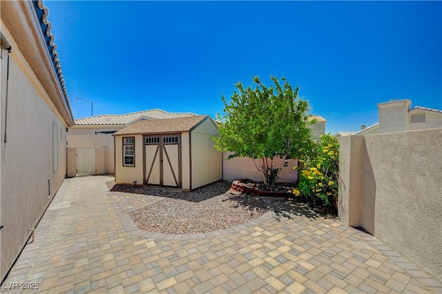 983 Cutter St, Henderson, NV 89011 - fenced backyard featuring a storage shed and a patio area