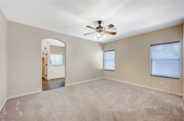 983 Cutter St, Henderson, NV 89011 - carpeted empty room featuring arched walkways, healthy amount of natural light, and ceiling fan