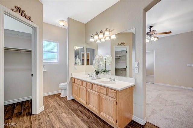 983 Cutter St, Henderson, NV 89011 - full bath with a ceiling fan, double vanity, a spacious closet, and wood finished floors