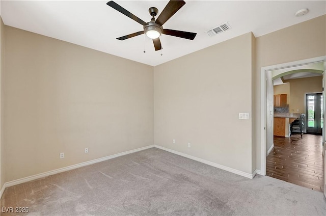983 Cutter St, Henderson, NV 89011 - unfurnished room featuring ceiling fan, carpet, arched walkways, and a smoke detector