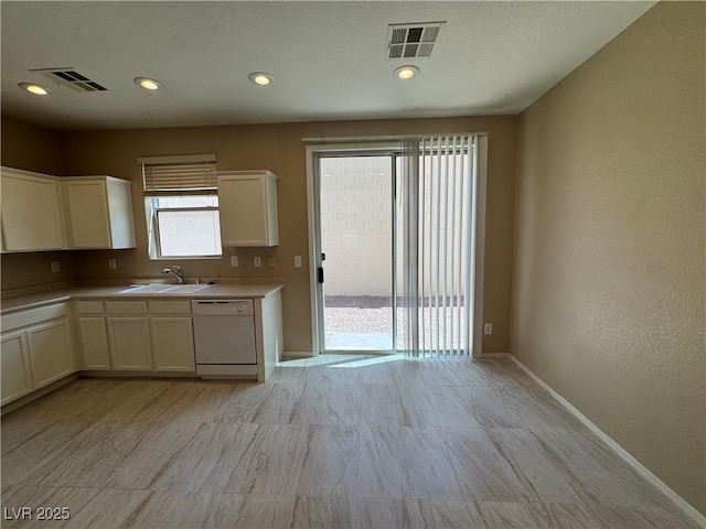 5861 Varese Dr, Las Vegas, NV 89141 - kitchen featuring white dishwasher, baseboards, white cabinets, a sink, and recessed lighting