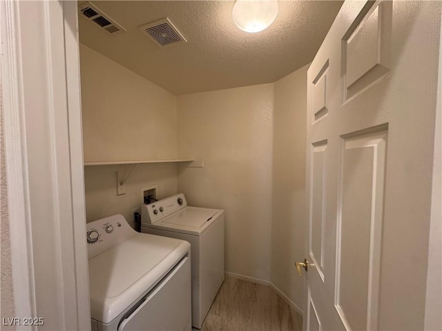 5861 Varese Dr, Las Vegas, NV 89141 - laundry room with washer and clothes dryer, a textured ceiling, and baseboards