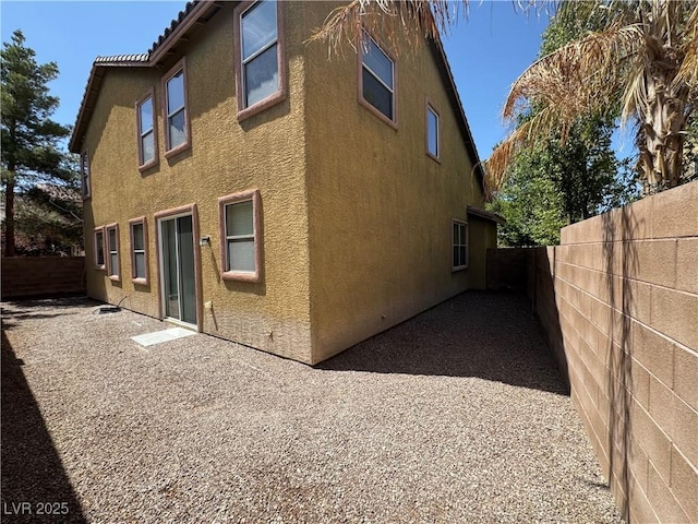 5861 Varese Dr, Las Vegas, NV 89141 - rear view of property featuring stucco siding and a fenced backyard