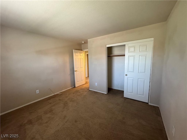 5861 Varese Dr, Las Vegas, NV 89141 - unfurnished bedroom featuring baseboards, dark colored carpet, and a closet
