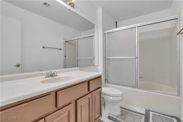 765 Butternut Ct, Henderson, NV 89014 - full bathroom with toilet, vanity, shower / bath combination with glass door, and tile patterned flooring