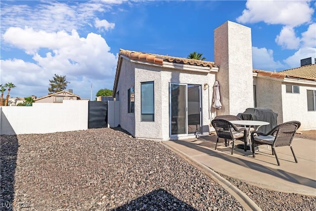 765 Butternut Ct, Henderson, NV 89014 - back of property featuring a patio, stucco siding, a tile roof, and a chimney