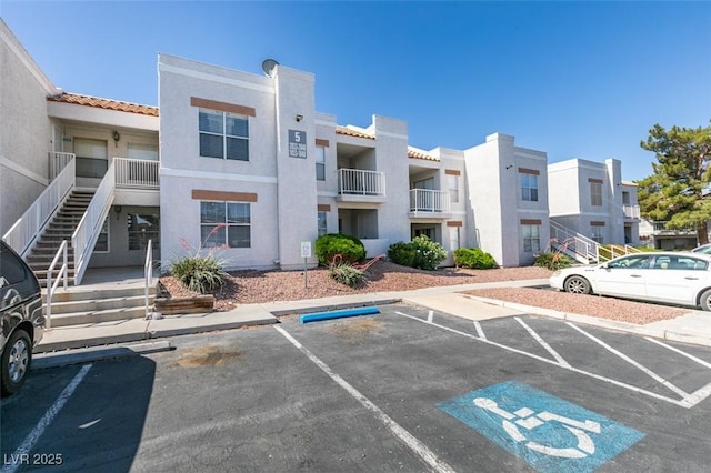 6800 E Lake Mead Blvd Unit 1034, Las Vegas, NV 89156 - view of property featuring stairway and uncovered parking