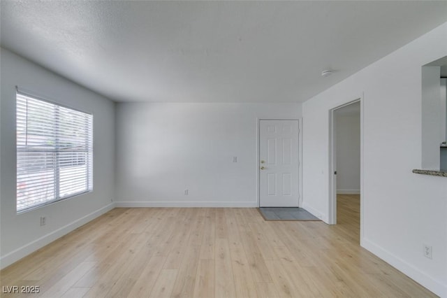6800 E Lake Mead Blvd Unit 1034, Las Vegas, NV 89156 - empty room with light wood finished floors, baseboards, and a smoke detector