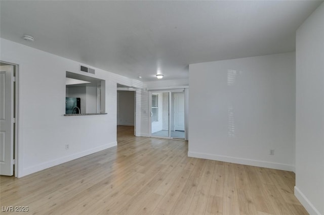 6800 E Lake Mead Blvd Unit 1034, Las Vegas, NV 89156 - empty room with baseboards, light wood finished floors, and a smoke detector