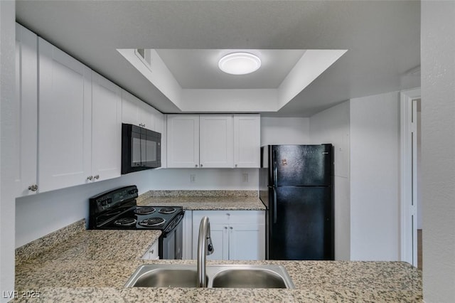 6800 E Lake Mead Blvd Unit 1034, Las Vegas, NV 89156 - kitchen with black appliances, a sink, a tray ceiling, and white cabinets