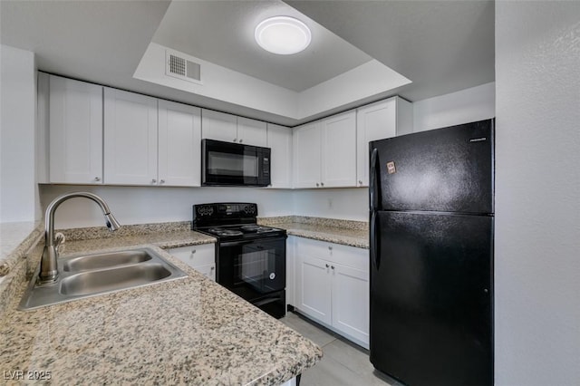 6800 E Lake Mead Blvd Unit 1034, Las Vegas, NV 89156 - kitchen featuring black appliances, a sink, light countertops, white cabinets, and a tray ceiling