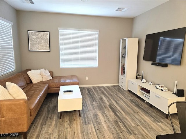8534 Insignia Ave Unit 101, Las Vegas, NV 89178 - living room featuring dark wood finished floors, plenty of natural light, and baseboards
