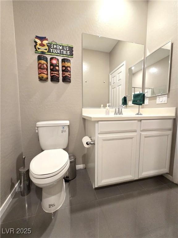 8534 Insignia Ave Unit 101, Las Vegas, NV 89178 - half bath featuring vanity, toilet, and baseboards