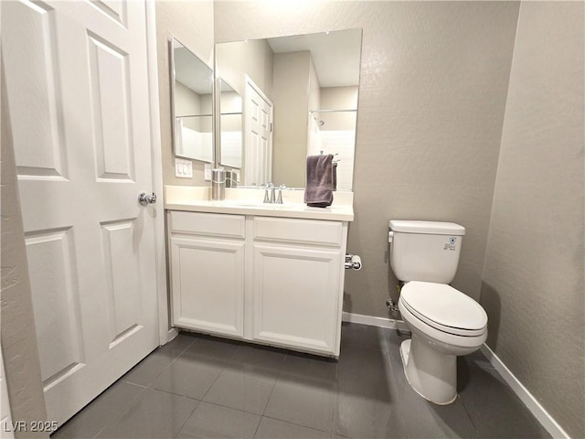 8534 Insignia Ave Unit 101, Las Vegas, NV 89178 - full bathroom with toilet, vanity, tile patterned flooring, a shower, and baseboards