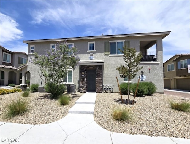 8534 Insignia Ave Unit 101, Las Vegas, NV 89178 - view of front of home with stucco siding, central AC, and stone siding