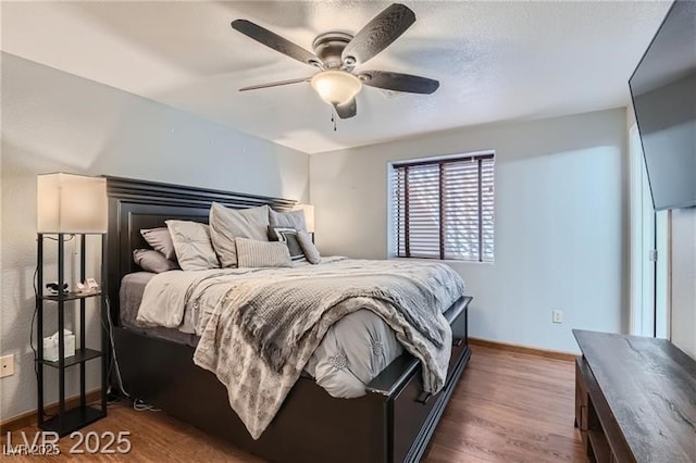 4075 E Oquendo Rd, Las Vegas, NV 89120 - bedroom featuring dark wood-type flooring, baseboards, and a ceiling fan