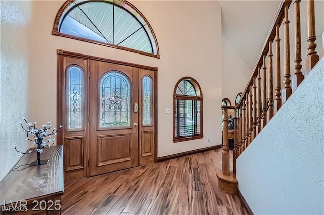 4075 E Oquendo Rd, Las Vegas, NV 89120 - foyer featuring a towering ceiling, stairs, and wood finished floors