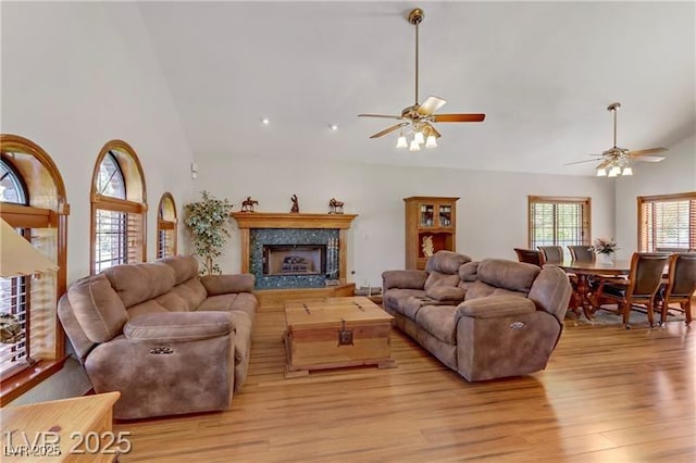 4075 E Oquendo Rd, Las Vegas, NV 89120 - living area with ceiling fan, high vaulted ceiling, light wood finished floors, and a fireplace with raised hearth