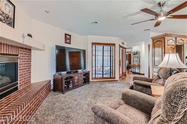 4075 E Oquendo Rd, Las Vegas, NV 89120 - carpeted living area with a brick fireplace and ceiling fan