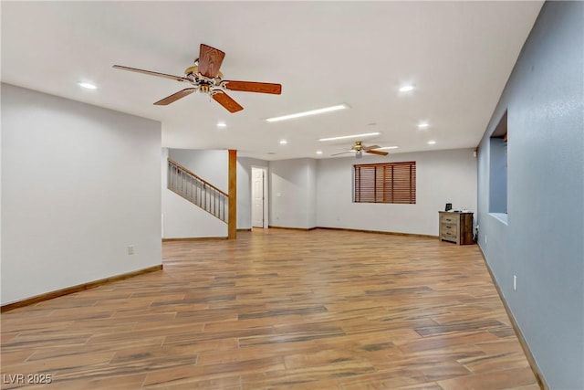 4075 E Oquendo Rd, Las Vegas, NV 89120 - unfurnished living room featuring ceiling fan, stairway, light wood-type flooring, recessed lighting, and baseboards