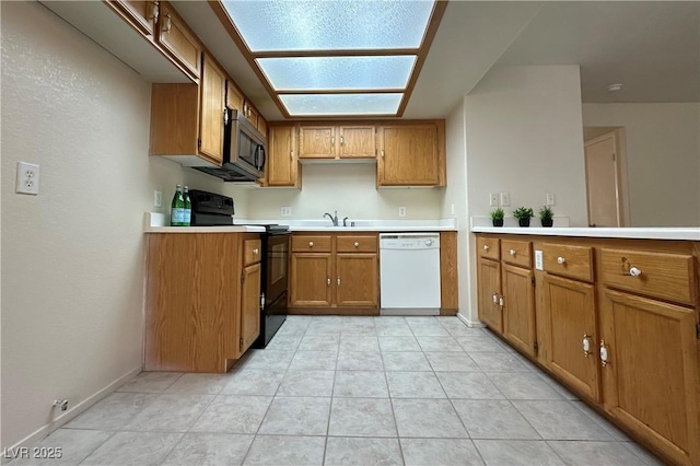 8410 Eldora Ave Unit 2046, Las Vegas, NV 89117 - kitchen with dishwasher, black electric range oven, brown cabinets, stainless steel microwave, and light countertops