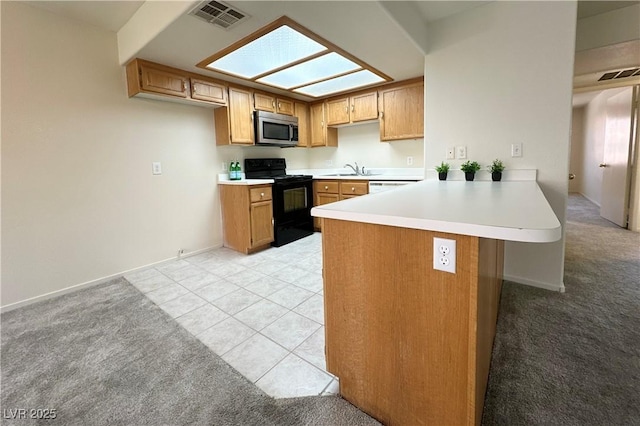 8410 Eldora Ave Unit 2046, Las Vegas, NV 89117 - kitchen with stainless steel microwave, black range with electric stovetop, a peninsula, light carpet, and light countertops