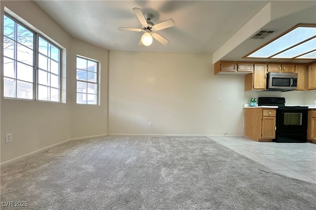 8410 Eldora Ave Unit 2046, Las Vegas, NV 89117 - kitchen featuring stainless steel microwave, black / electric stove, light colored carpet, and baseboards