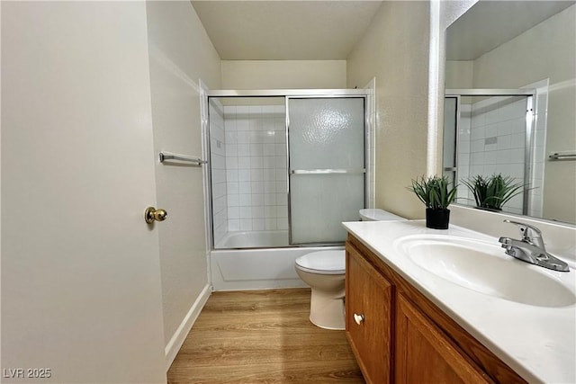 8410 Eldora Ave Unit 2046, Las Vegas, NV 89117 - full bathroom featuring toilet, vanity, wood finished floors, and shower / bath combination with glass door