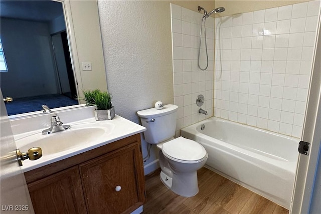 8410 Eldora Ave Unit 2046, Las Vegas, NV 89117 - bathroom with vanity, wood finished floors, toilet, bathtub / shower combination, and a textured wall