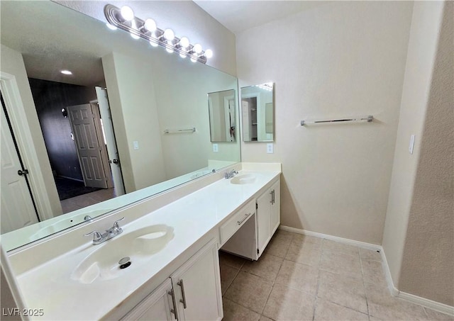 2035 E Warm Springs Rd Unit 1017, Las Vegas, NV 89119 - full bathroom featuring double vanity, baseboards, and tile patterned flooring