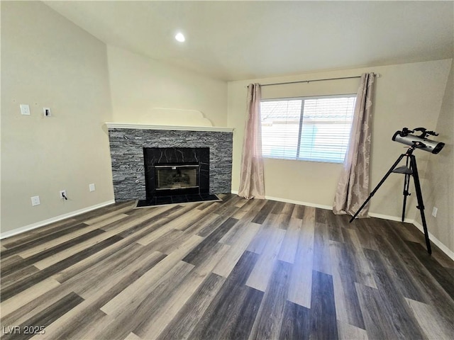 2035 E Warm Springs Rd Unit 1017, Las Vegas, NV 89119 - unfurnished living room with a stone fireplace, wood finished floors, and baseboards