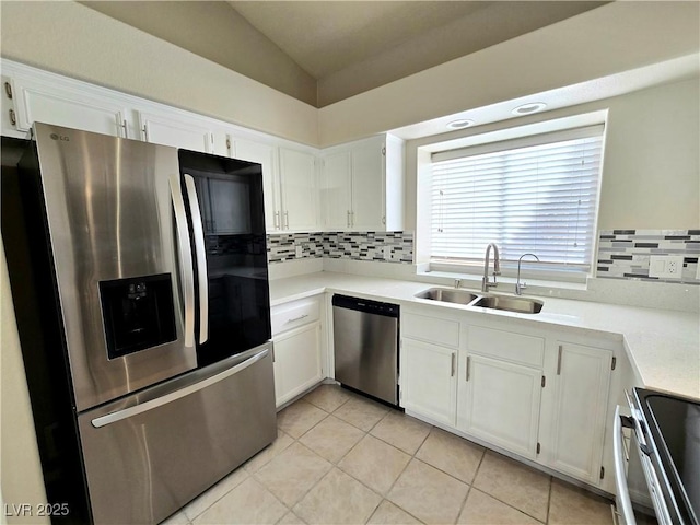 2035 E Warm Springs Rd Unit 1017, Las Vegas, NV 89119 - kitchen featuring stainless steel appliances, a sink, backsplash, vaulted ceiling, and white cabinets