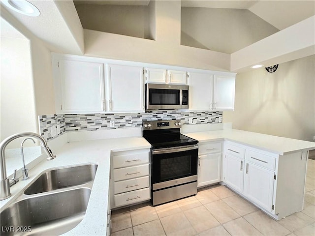 2035 E Warm Springs Rd Unit 1017, Las Vegas, NV 89119 - kitchen with stainless steel appliances, a sink, a peninsula, backsplash, and white cabinets