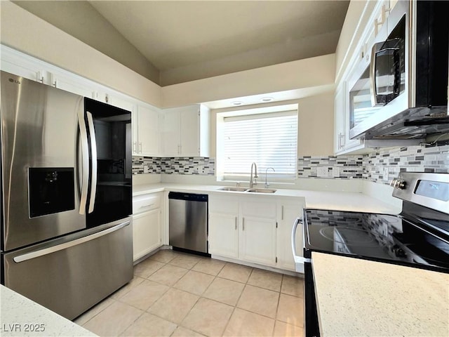 2035 E Warm Springs Rd Unit 1017, Las Vegas, NV 89119 - kitchen with stainless steel appliances, a sink, white cabinets, light countertops, and vaulted ceiling