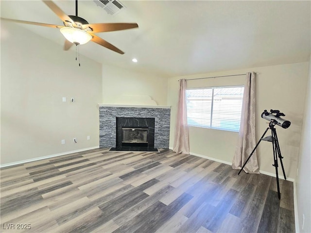 2035 E Warm Springs Rd Unit 1017, Las Vegas, NV 89119 - unfurnished living room with ceiling fan, wood finished floors, a stone fireplace, baseboards, and lofted ceiling