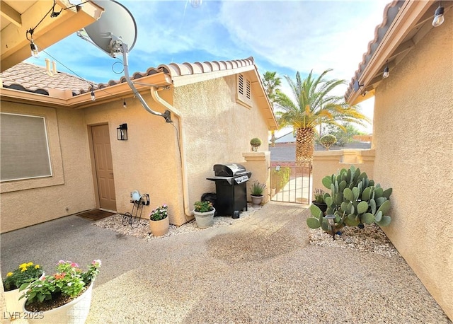 2035 E Warm Springs Rd Unit 1017, Las Vegas, NV 89119 - view of property exterior with stucco siding and a gate