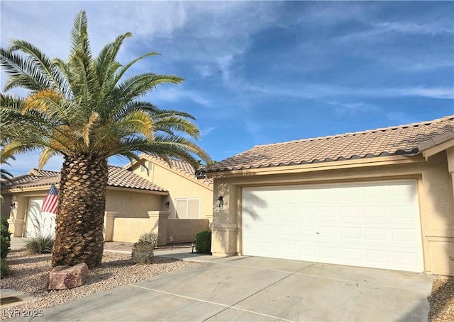 2035 E Warm Springs Rd Unit 1017, Las Vegas, NV 89119 - mediterranean / spanish-style house featuring concrete driveway, stucco siding, and a tiled roof
