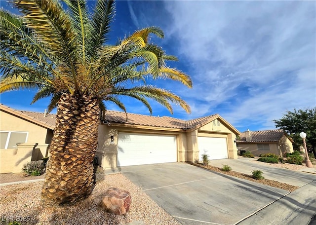 2035 E Warm Springs Rd Unit 1017, Las Vegas, NV 89119 - ranch-style house with stucco siding, driveway, a tile roof, and a garage
