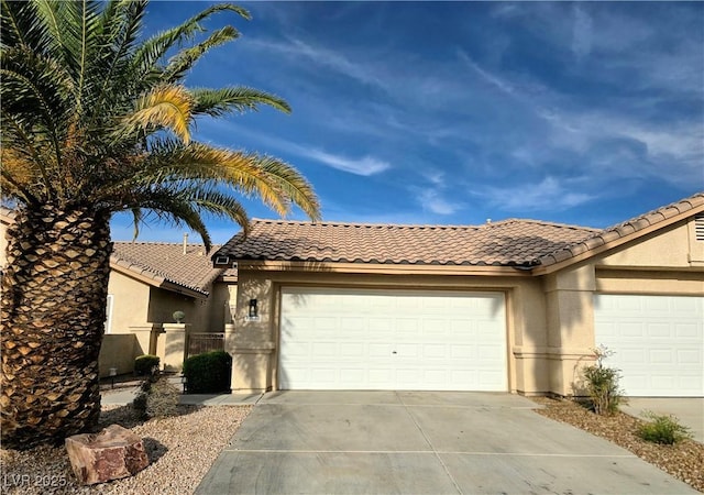 2035 E Warm Springs Rd Unit 1017, Las Vegas, NV 89119 - view of front of property featuring driveway, stucco siding, and a tile roof