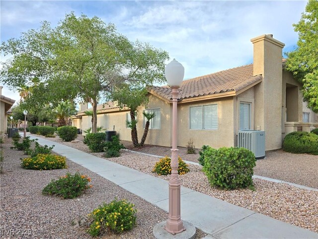 2035 E Warm Springs Rd Unit 1017, Las Vegas, NV 89119 - view of front of home featuring cooling unit, stucco siding, and a tiled roof