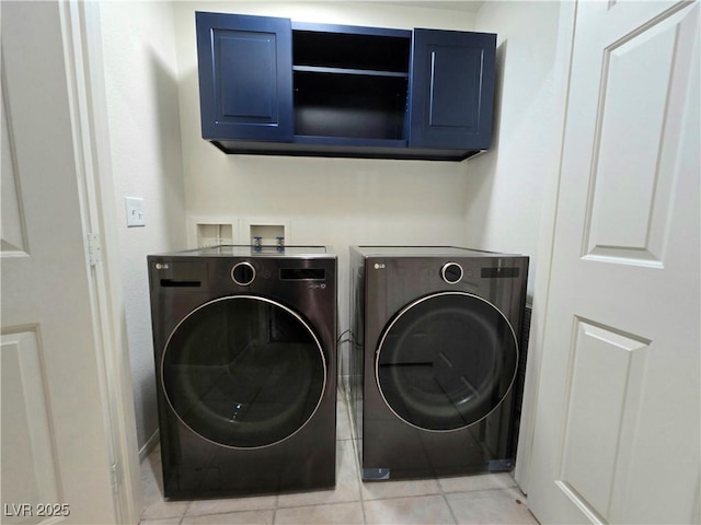 2035 E Warm Springs Rd Unit 1017, Las Vegas, NV 89119 - washroom featuring washing machine and dryer, light tile patterned floors, and cabinet space