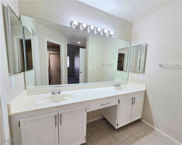 2035 E Warm Springs Rd Unit 1017, Las Vegas, NV 89119 - bathroom with double vanity, tile patterned floors, and baseboards